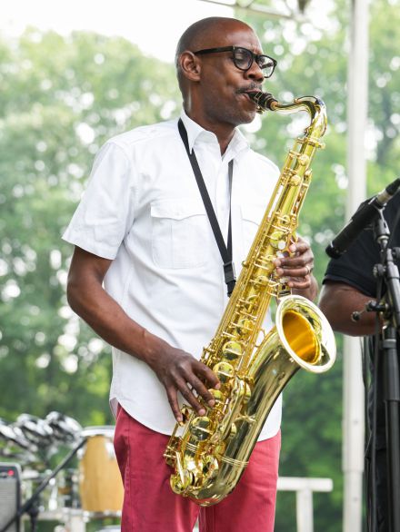 a man playing a saxophone on a stage